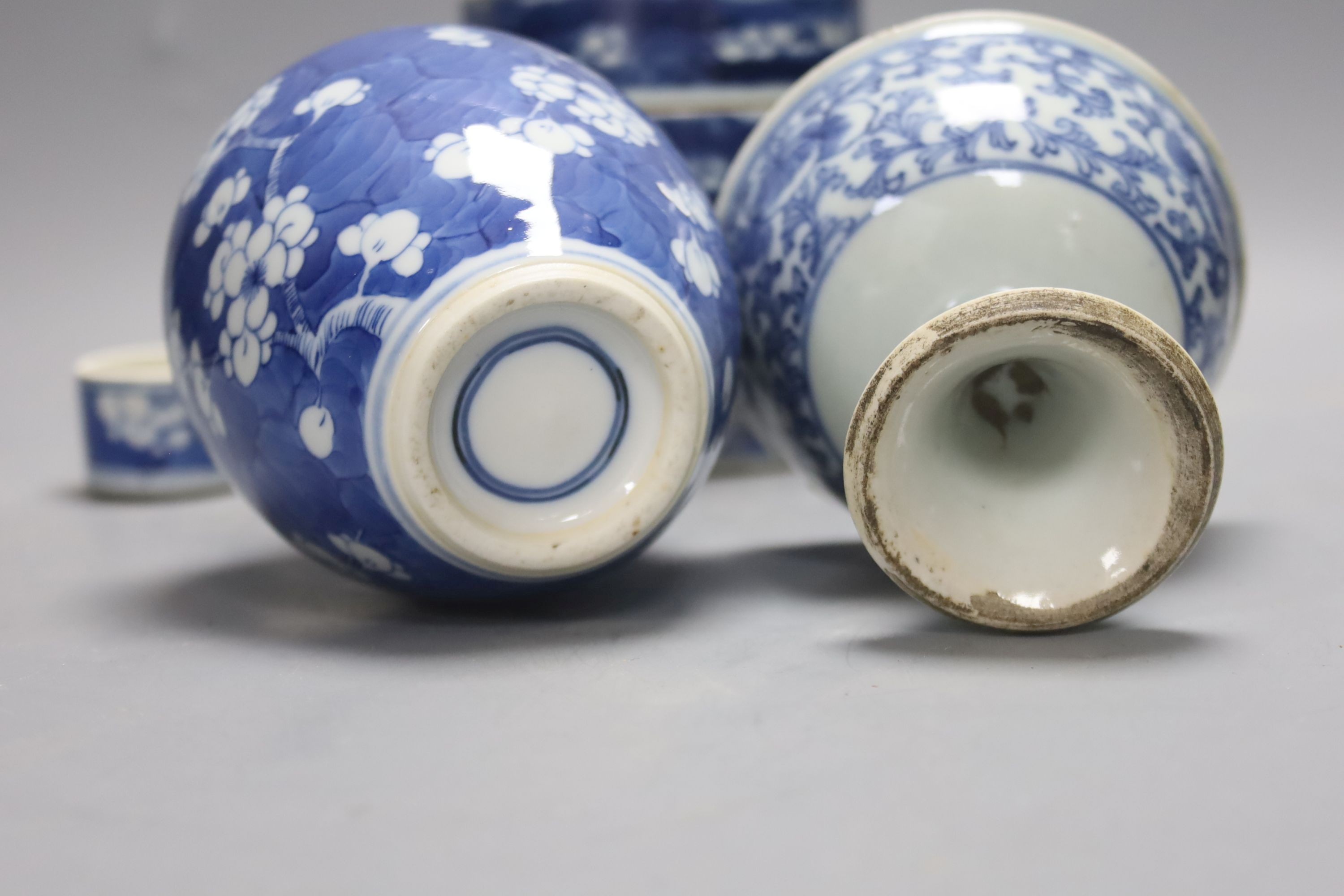 A Chinese blue and white ovoid jar and cover and similar stacking box, Kangxi and a Qing blue and white footed cup, tallest 15cm